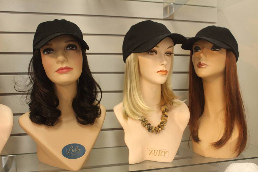 For clients who want to exercise or wear a hat while wearing hair, Master Hair Care offers different hats and caps with small hair pieces attached. Photo by Bailey Jo Josie/Sound Publishing.