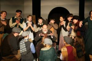 Lee Howard as Fagin surrounded by the youth in our 2019 production of Oliver! Photo provided by St Lukes.