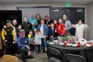 After three hours of food and conversation, guests and hosts of the Iftar dinner hosted at Veritas Church by the Al-Maidah Initiative pose together for a photo at the end of the evening. Photo by Keelin Everly-Lang / The Mirror