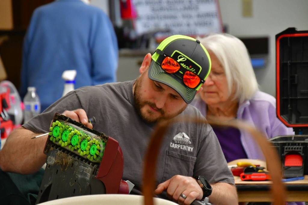 Vacuum fixes were a popular request at the Repair Cafe. Photos by Bruce Honda