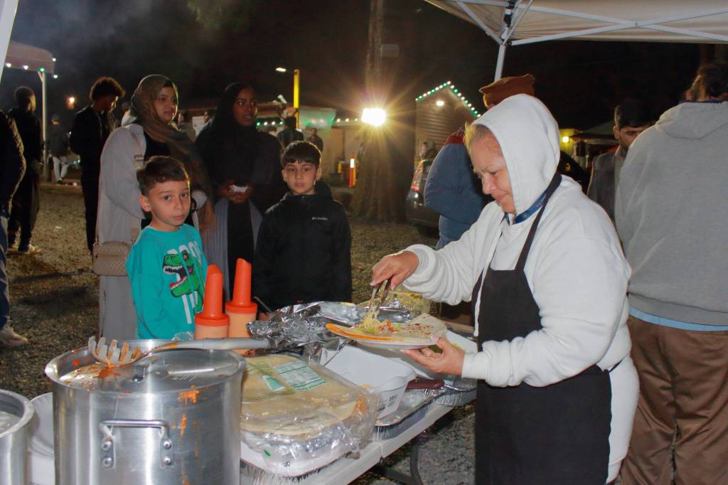 Alicia Sainz serves quesadillas made with halal chicken to waiting guests on the final night of Ramadan during the Chand Raat Mela event. Photos by Keelin Everly-Lang / the Mirror