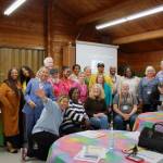 Attendees of the participatory budgeting event gather for a group photo after sharing their support for their top ideas at the event. Photos by Keelin Everly-Lang / The Mirror