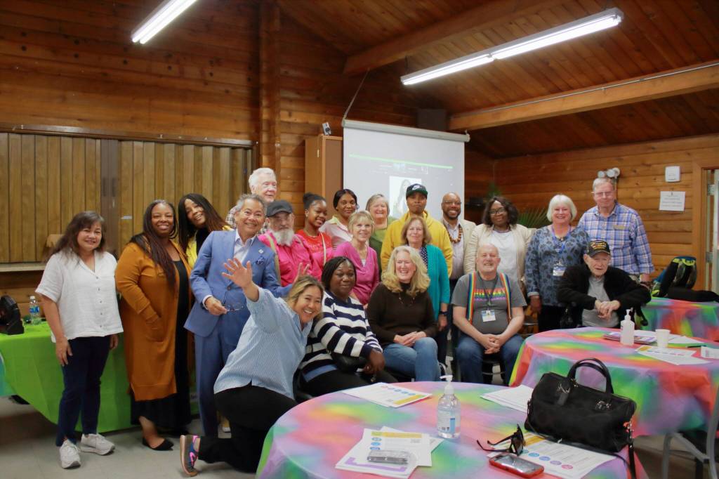 Attendees of the participatory budgeting event gather for a group photo after sharing their support for their top ideas at the event. Photos by Keelin Everly-Lang / The Mirror