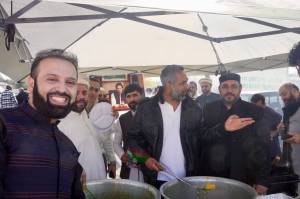 Men serving halal food on Eid Mubarak 2024. Photo By Joshua Solorzano/Federal Way Mirror