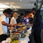 Student-athletes and others serve themselves breakfast at the Scholar-Athlete Breakfast.