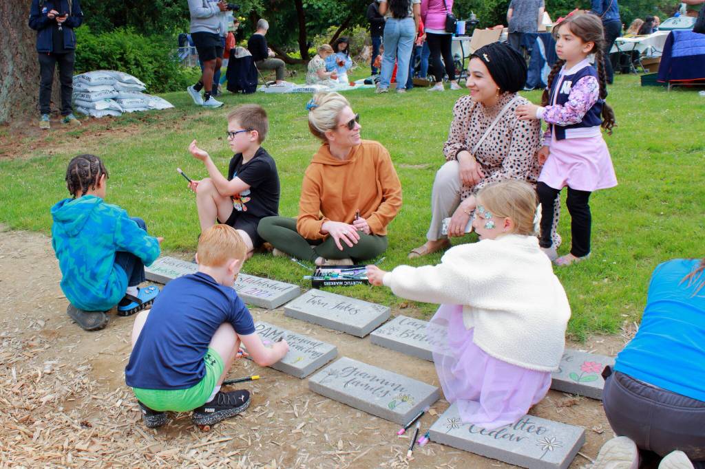 Families connected with one another as kids got to participate in decorating stones for the Twin Lakes community garden. Photo by Keelin Everly-Lang / The Mirror
