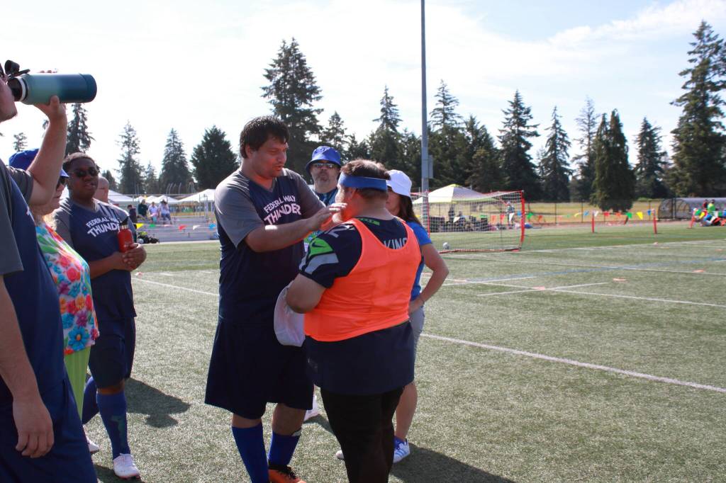 John Emmett shares some positive words with goalie and team mate Nick King after their first game on Saturday, June 8.
