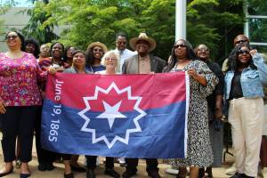 In 2023, city leaders and community members hold the Juneteenth flag outside Federal Way City Hall. File photo