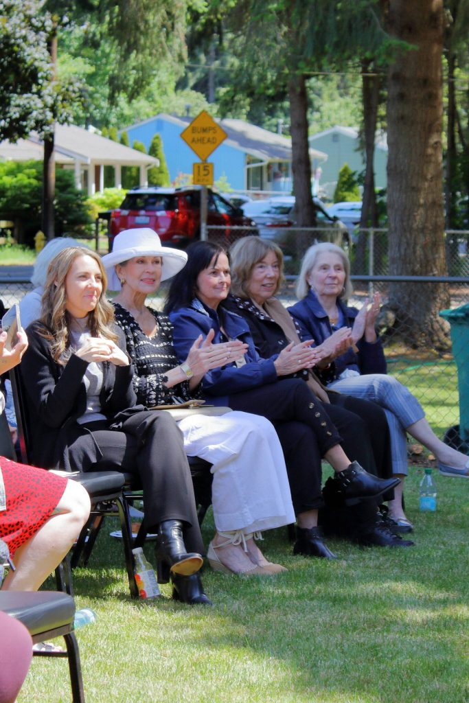 Members of FUSIONs board applaud the ribbon cutting of the Carpenter House. The house is the largest to join a fleet of other homes that the organization utilizes in their transitional housing program. Photo by Keelin Everly-Lang / The Mirror