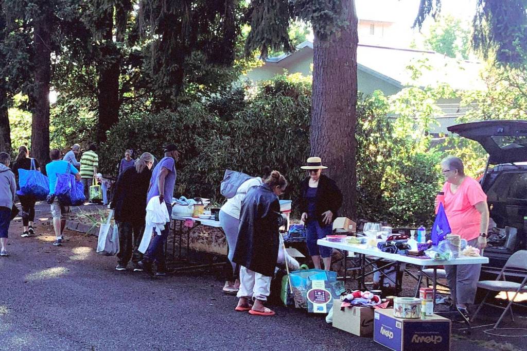 Tables stretched out under the trees to hold a variety of household items, distributed for free at the first free market. Photo provided by the Federal Way United Methodist Church