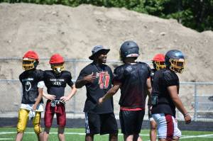 Tremain Mack, new head coach for the Thomas Jefferson High School football team, works with players during summer practices. Ben Ray / The Mirror