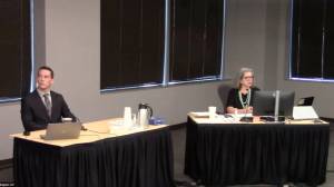 Federal Way Police Department Officer Charles Hinkle and Inquest Program Manager Marcine Anderson. (Screenshot)