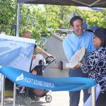 John Mannetti of PSE presents an award to Estela Ortega of El Centro de la Raza. The award was crafted from an upcycled utility pole. Photo by Keelin Everly-Lang / the Mirror