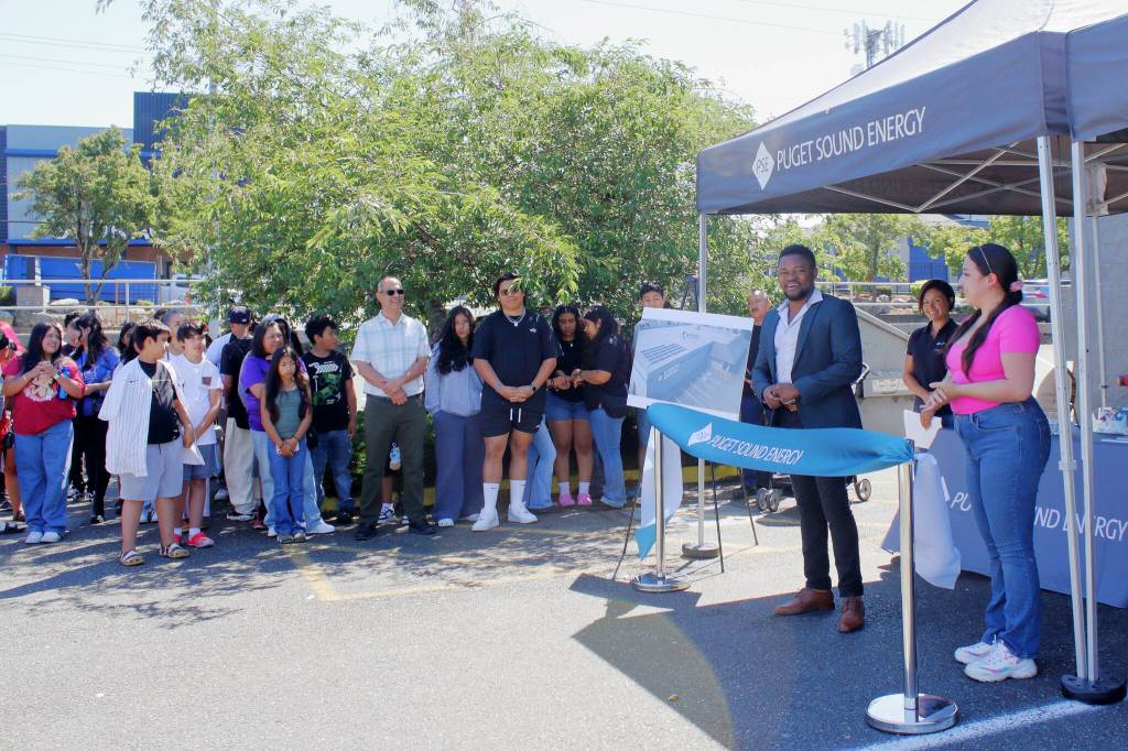 Edwin Wanji, Founder and CEO of Sphere Solar Energy, speaks at the ribbon cutting. Staff member Jessica Ramirez translated to make sure everyone could be part of the conversation. Photo by Keelin Everly-Lang / the Mirror