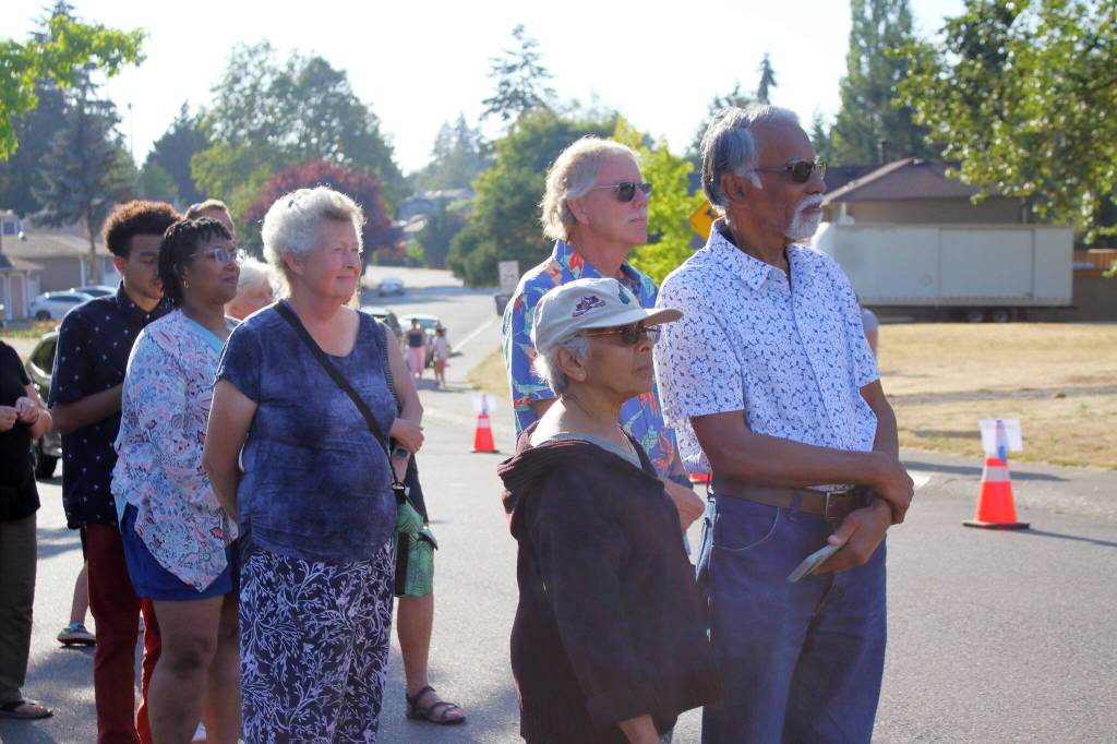 Neighbors listen to a rendition of the national anthem from Liv Rion before the ribbon cutting ceremony for new neighborhood cameras. Photo by Keelin Everly-Lang / the Mirror.