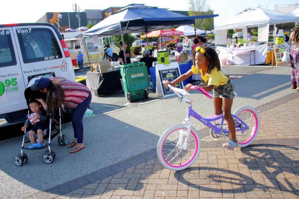There were many opportunities to play and get active at the Federal Way Community Festival, whether it was on a bike riding past the food trucks and tents or in the bouncy house or spray park. Photo by Keelin Everly-Lang / the Mirror