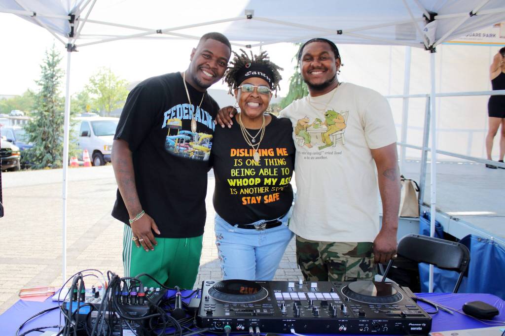 DJ Yohiness was one of the main DJs for the Federal Way Community Festival this year. Here with his family Heshineah Jahseen and Kevon Richmond at the DJ booth. Photo by Keelin Everly-Lang / the Mirror