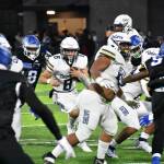 Decatur quarterback Spencer Holloway keeps his eyes down field with the ball in his hands. (Photo by Ben Ray/Sound Publishing)