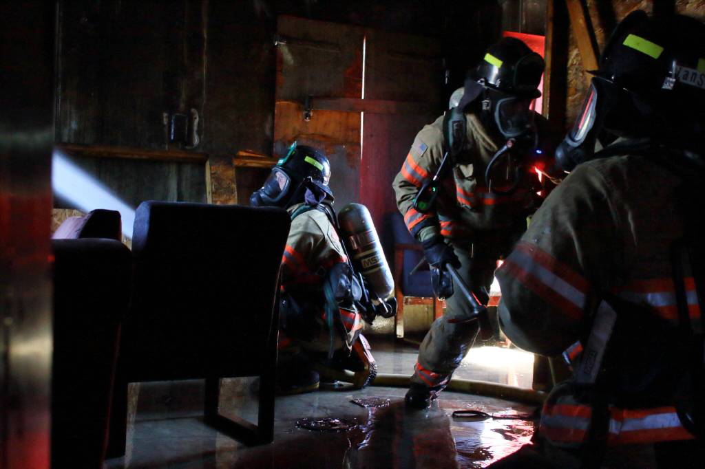 Probationary firefighters practice a scenario on the third floor of a training tower as part of their post-academy training. Photo by Keelin Everly-Lang / The Mirror