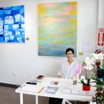 Photo by Keelin Everly-Lang / the Mirror 
Soo Yi is an employee at Ace Massage Chairs, a business housed within Gallery K. Behind her is an art piece that may appear to be a painting. Instead, it is an example of a beautiful Korean traditional paper with many textures and colors woven into its fibers.