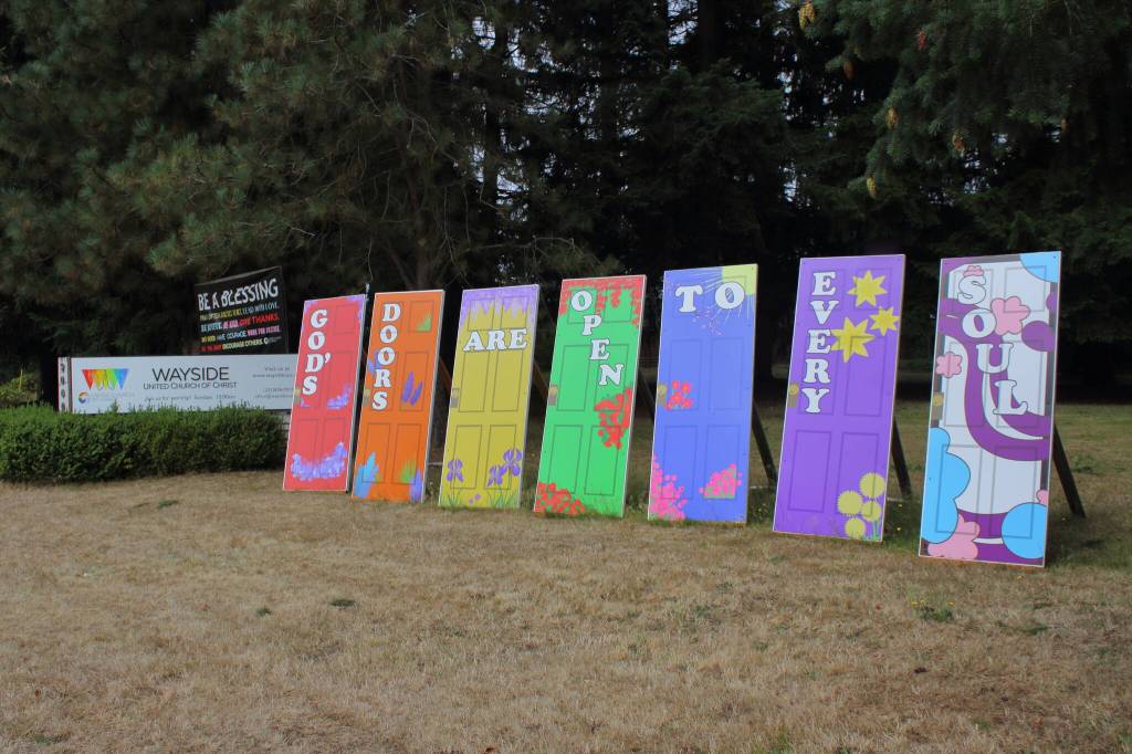 These doors are displayed at the intersection of Southwest Dash Point Road and 21st Avenue Southwest in front of the church.