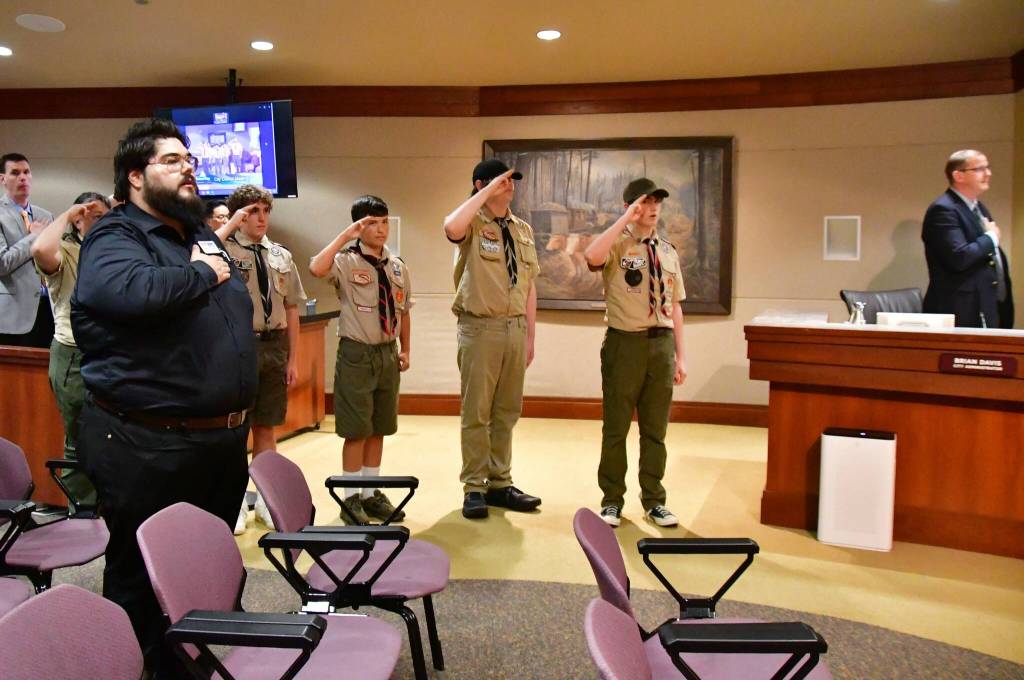 Boy Scouts led the Pledge of Allegiance at the City Council meeting, helping them earn badges for civic duty and communication. Photo by Bruce Honda