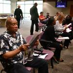 A community member reads the Mirror while waiting for the City Council meeting to begin. Photo by Bruce Honda.