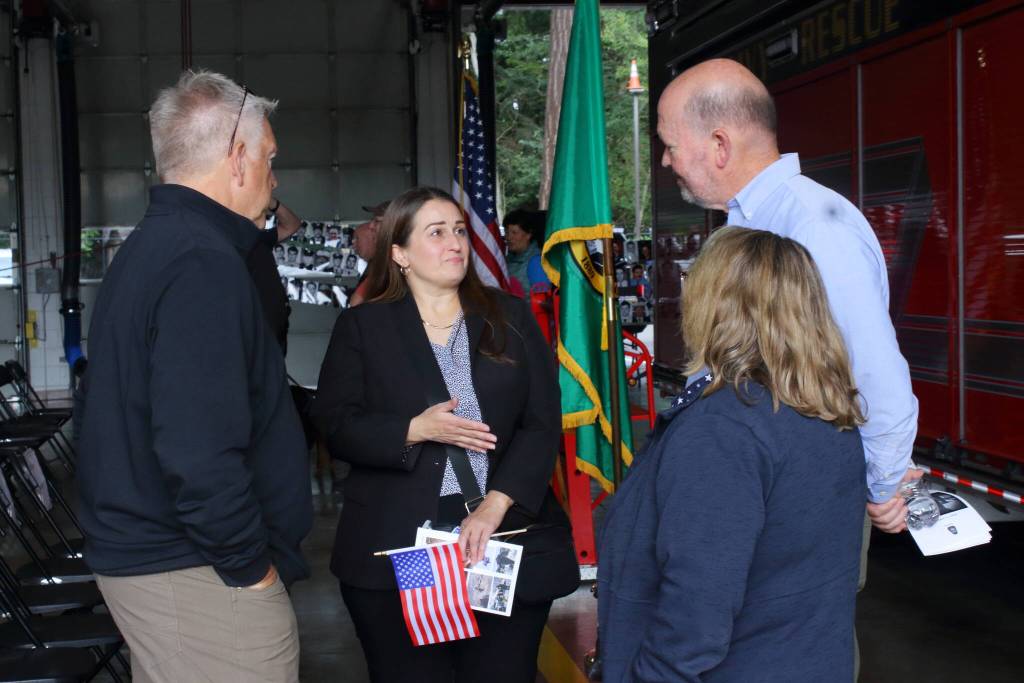 Quentin Morris and Melissa Hamilton speak with Councilmember Jack Walsh and his wife Judy at the 9/11 memorial tribute. Photo by Keelin Everly-Lang / the Mirror
