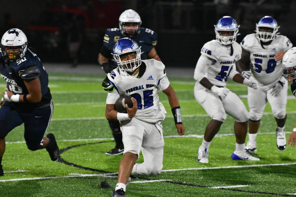 Jojo Fuavai runs the ball for Federal Way against Decatur. Ben Ray / The Mirror