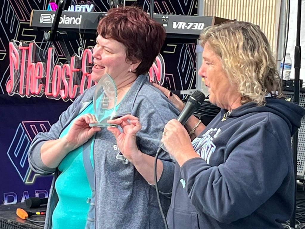 Mimi Meeker, left, was honored for her work with local charity Do The Right Thing and its founder Cheryl Hurst.