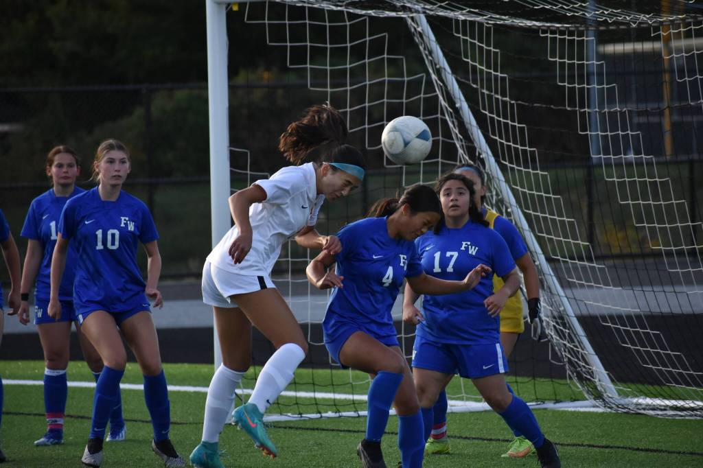 Thomas Jeffersons Callie Moore gets a head on a cross against the Eagles.
