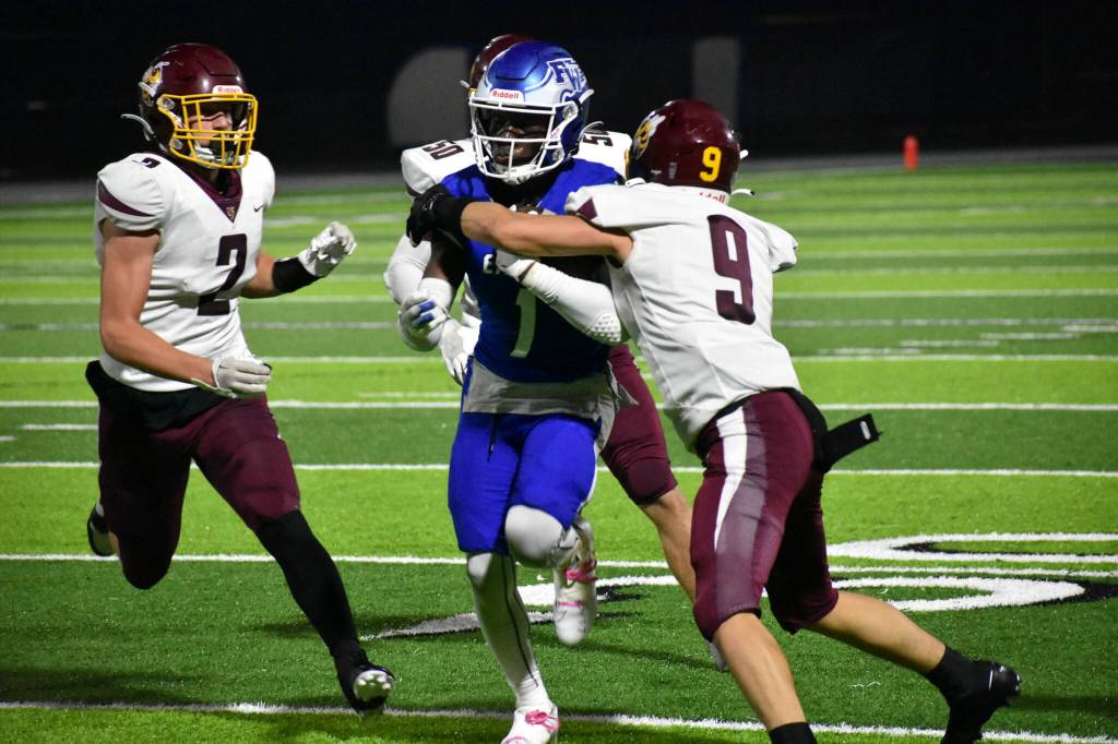 Zamarie Tellez looks to break a tackle against White River in the 15-0 win. Ben Ray / The Mirror