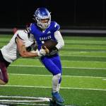 Andy Cortez shakes off a tackler while scrambling for Federal Way. Ben Ray / The Mirror