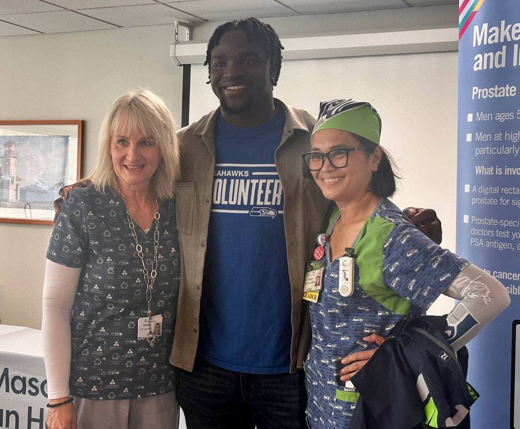 Boye Mafe with Virginia Mason nurses Dorota Irga and Vangie Villa. Photo by Joshua Solorzano/The Mirror