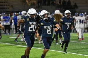 Decaturs Maddox Heyliger (20) and Spencer Holloway (8) celebrate by running over to fans together after defeating Federal Way. Ben Ray / The Mirror