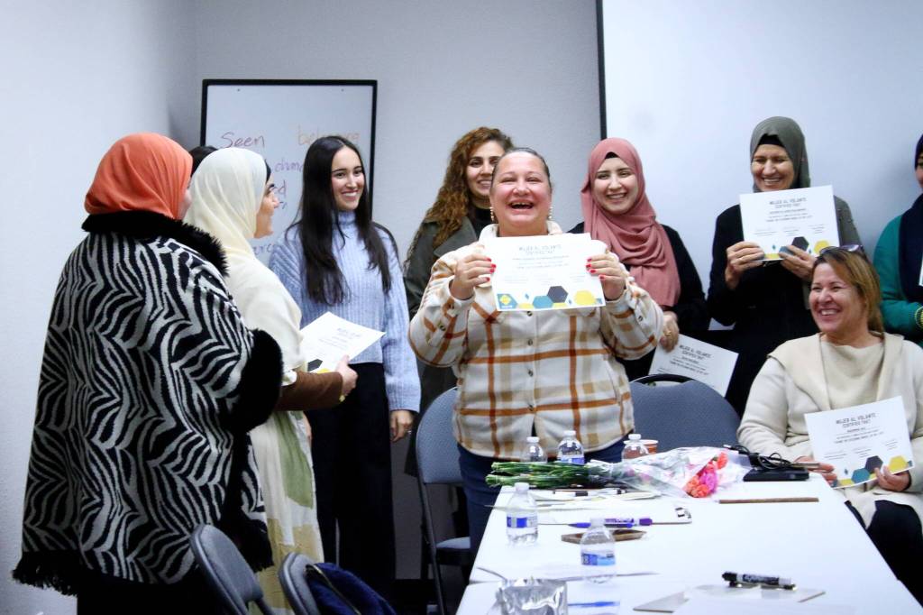 Abeer Haleem Awadalaa Rezkalaa receives her graduation certificate at Mujer al Volante on Nov. 11. Photos by Keelin Everly-Lang / the Mirror