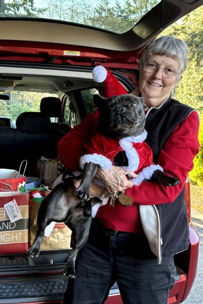 Maxine Ranta and her dog Jaxson accompanied the Marine Hills Garden Club members to deliver gifts and floral arrangements this holiday season. Photo provided by Debbie Angel