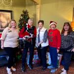 Rachel OReilly from Life Care Center, Maxine Ranta, Diane Goss, Penny Merriman, and Carrie Asselin working together to brighten the holidays for everyone. Photo provided by Debbie Angel