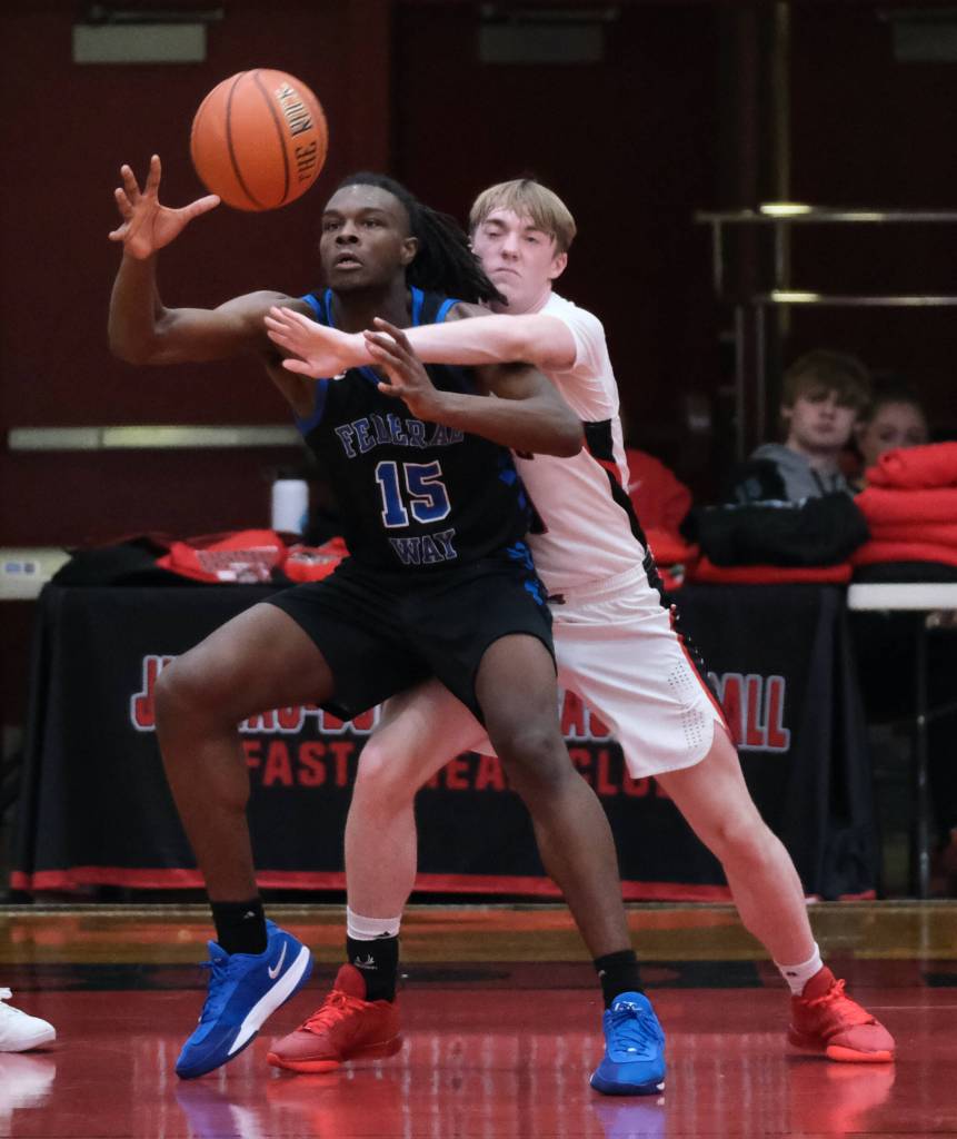 Juneau-Douglas High School: Yadaa.at Kalé senior Ben Sikes (11) defends Federal Way senior Saxon Niles (15) during the Crimson Bears 61-48 loss to the Eagles in the boys championship game at the George Houston Capital City Classic on Sunday in Juneau. (Klas Stolpe / Juneau Empire)