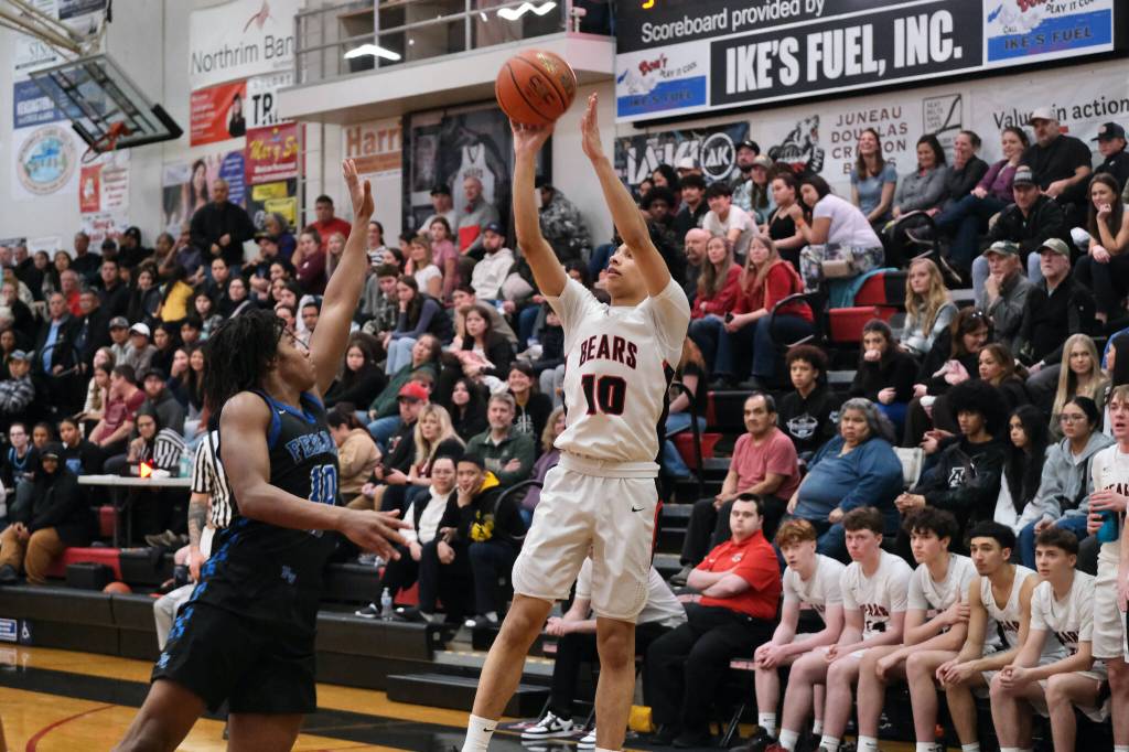Juneau-Douglas High School: Yadaa.at Kalé senior Pedrin Saceda-Hurt (10) shoots over Federal Way senior Jacob Hurskin (10) during the Crimson Bears 61-48 loss to the Eagles in the boys championship game at the George Houston Capital City Classic on Sunday in Juneau. (Klas Stolpe / Juneau Empire)