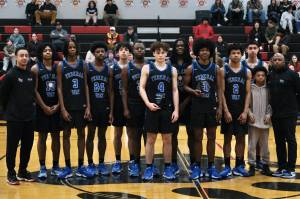 The Federal Way Eagles boys basketball team pose with their George Houston Capital City Classic championship trophy on Sunday. (Klas Stolpe / Juneau Empire)