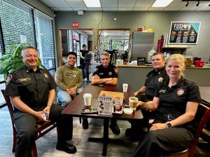 South King Fire Chief Dave Van Valkenburg, left, sits with a guest, District Chief Layne Winter, Deputy Chief Shane Smith and Deputy Chief Lisa Defenbaugh at Poverty Bay Cafe. File photo