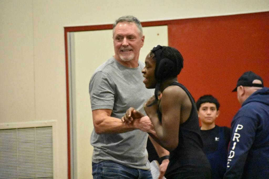Illahee coach Tom Eilertson gives a wrestler a high-five after a win. Ben Ray / The Mirror