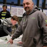 Kenny Garvin points to the location of his business, Tire City, and where three of the route alternatives intersect with it. Garvin shared his public comment at Sound Transits public hearing at the Federal Way Performing Arts and Event Center on Jan. 28. Photo by Keelin Everly-Lang / the Mirror