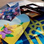 A photo of fallen soldiers from Ukraine, a heart created by a child in Ukraine to hearten soldiers in the war, medals given to Vitaliy Piekhotin for his work and a Ukrainian flag signed by volunteers delivering medical supplies. Photo by Keelin Everly-Lang / the Mirror