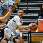 Titan senior Jaylin Wells looks for a teammate to pass the ball to in the corner. Ben Ray / The Mirror