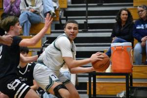 Titan senior Jaylin Wells looks for a teammate to pass the ball to in the corner. Ben Ray / The Mirror