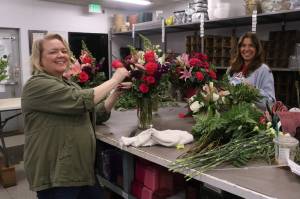 Carla Kostresh and Brianna Bri Sterling work hard arranging flowers for clients. Photo by Bailey Jo Josie/Sound Publishing