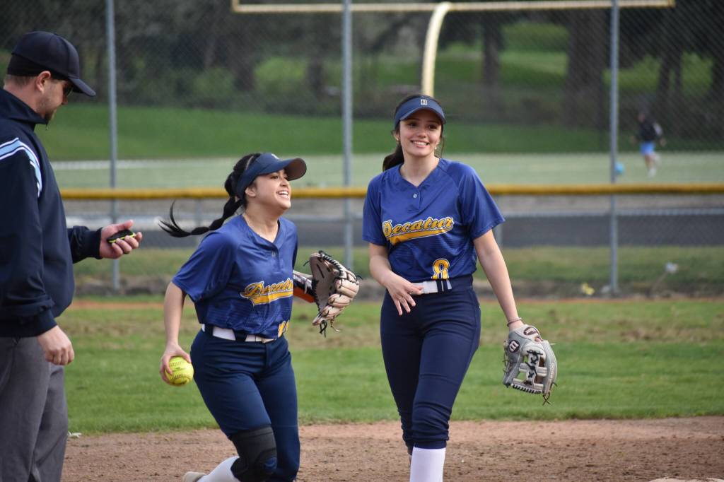 Luci Pech and Valentina Cruz-Castro smile after catching a pop fly. Ben Ray / The Mirror