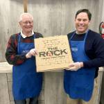 Bob Roegner, left, and Federal Way Mayor Jim Ferrell volunteer at a homeless shelter in 2019. File photo